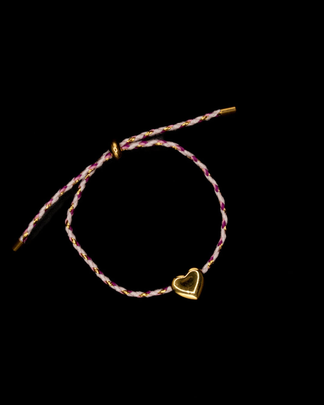 Bracelet with a heart charm on a dark background