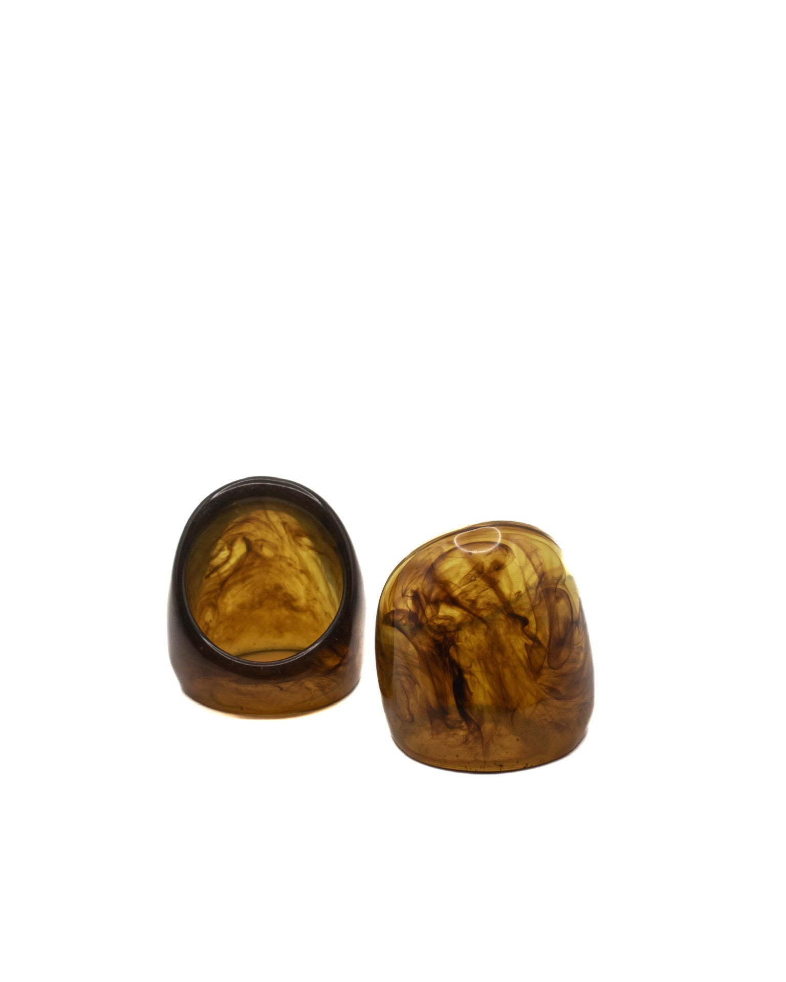 Two brown stone objects on a white background