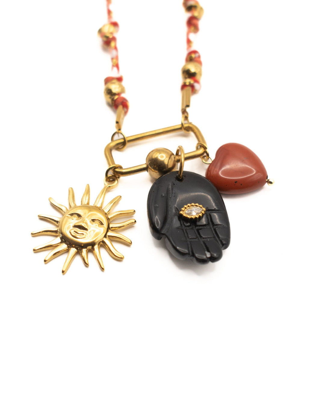 Necklace with sun, hand, and heart pendants on a white background
