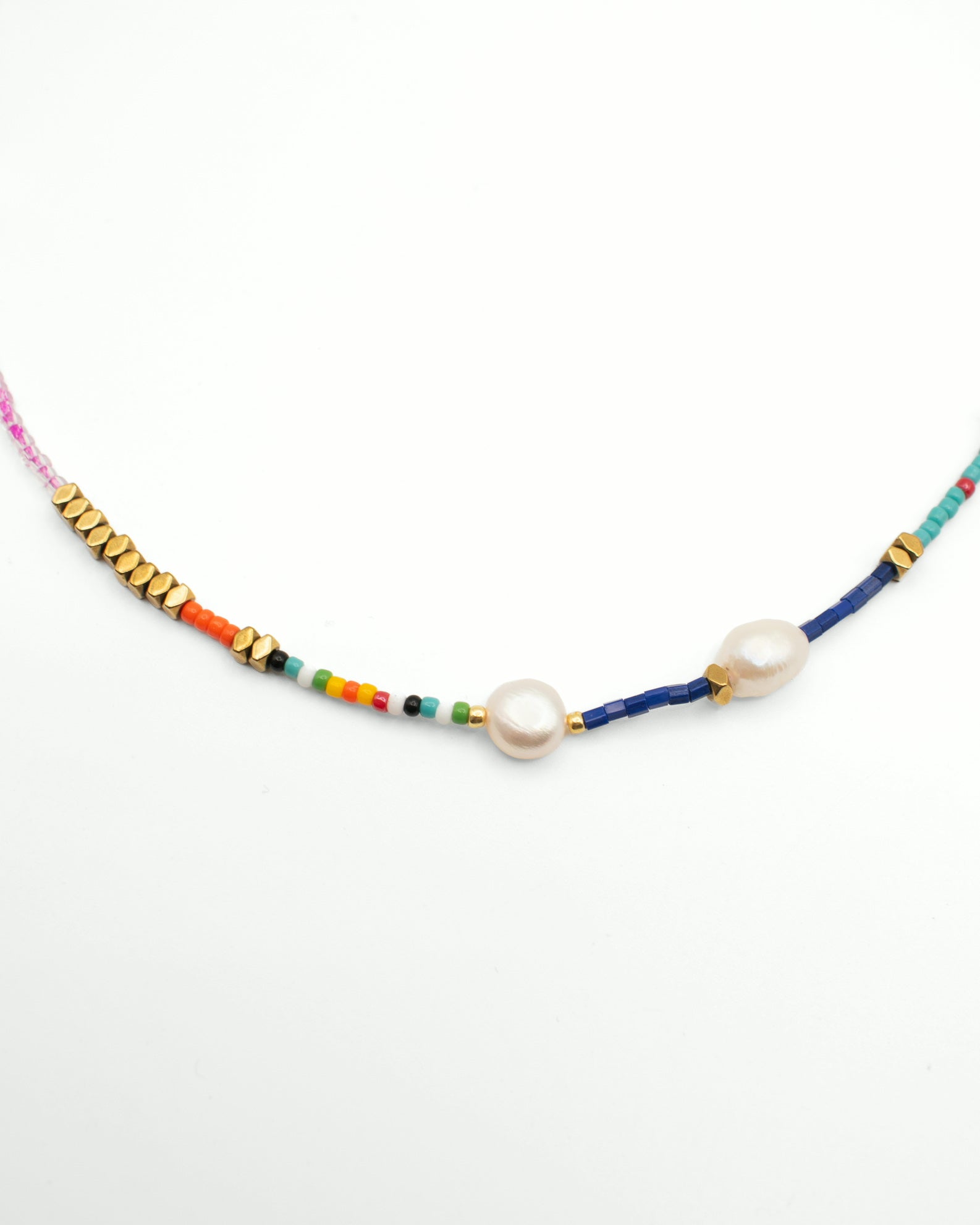 A beaded necklace featuring two large white freshwater pearls, gold spacer beads, and colorful thread strands in blue, pink, orange, green, and yellow on a white background.