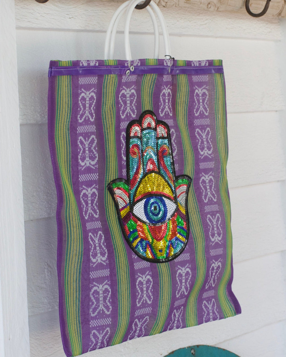 Colorful bag with a Hamsa hand design on a white background