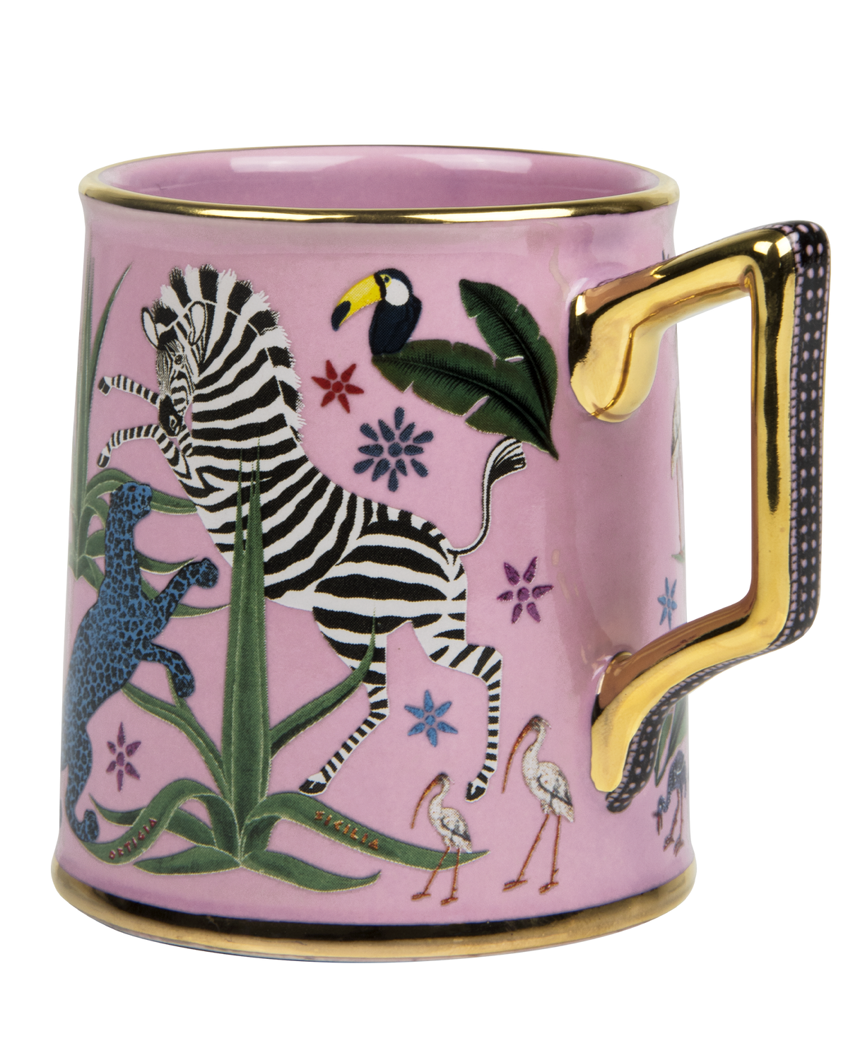 A pink ceramic mug with a gold handle and rim, decorated with a colorful safari illustration featuring a zebra, toucan, bird, flamingos, and foliage.