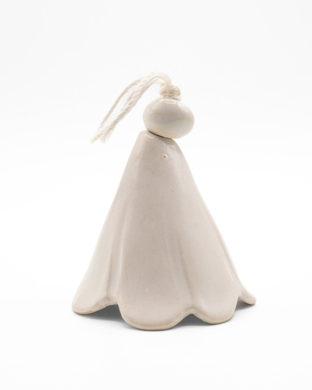 White ceramic ornament with a hanging loop on a white background