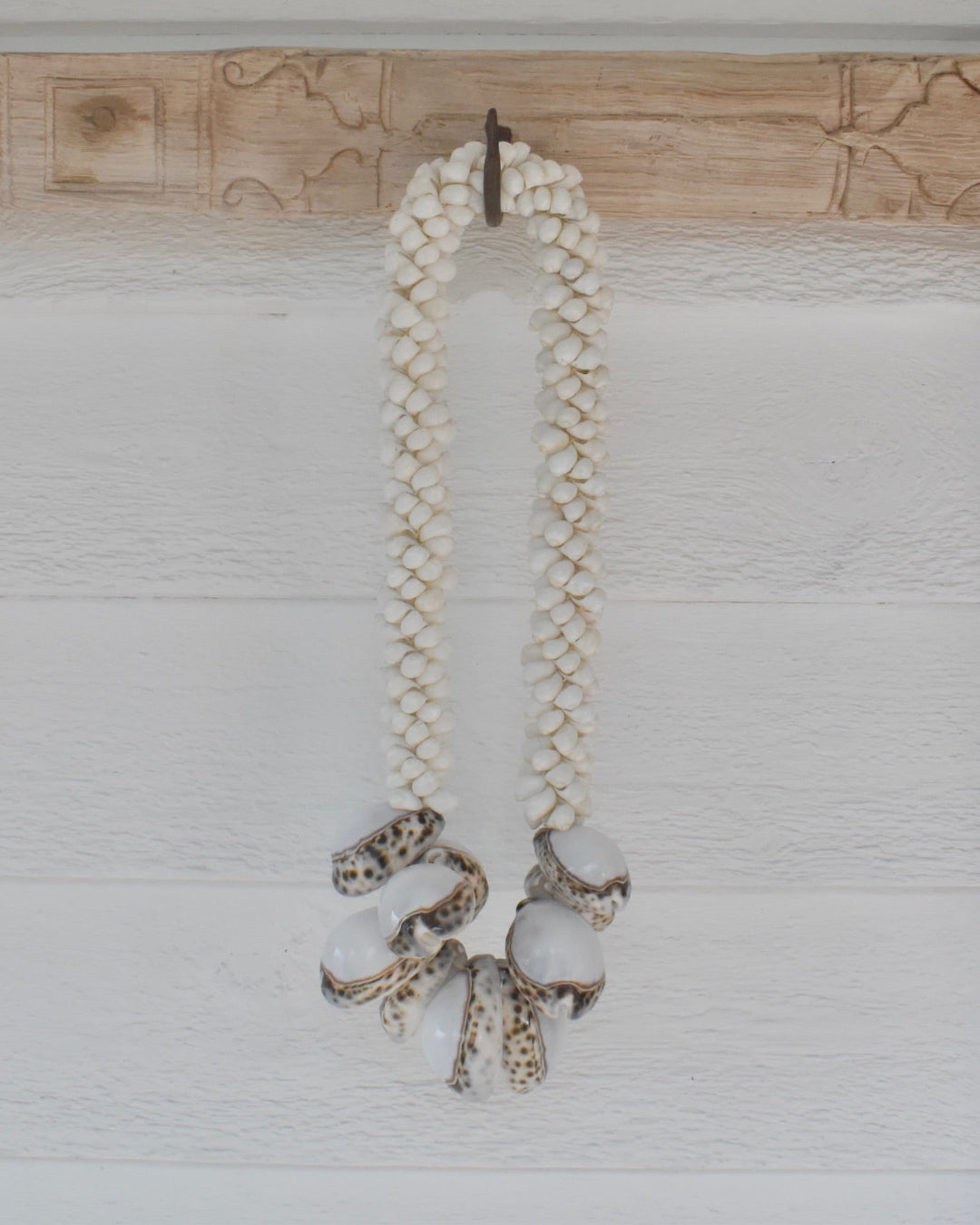 Necklace with braided design and octopus charms on a wooden surface