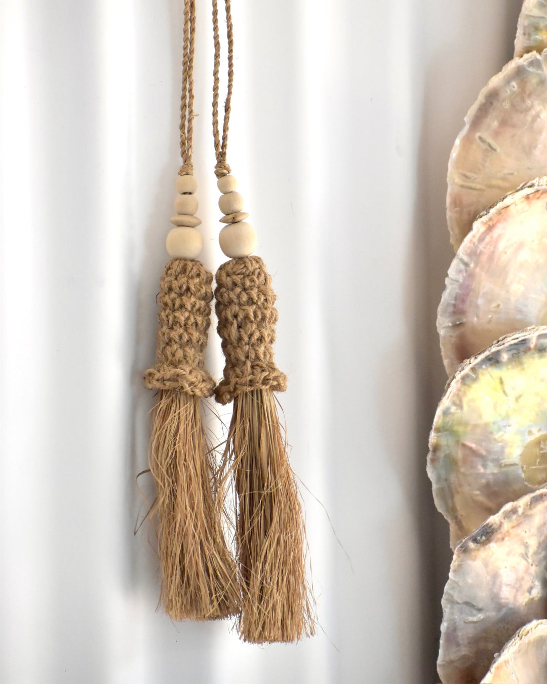 Decorative tassels with natural fibers on a white background