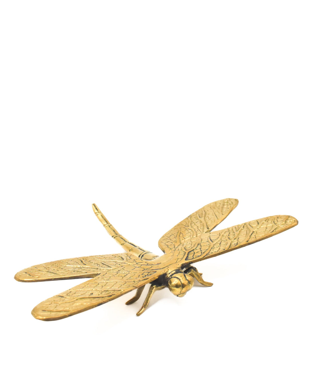 Gold dragonfly-shaped object on a white background