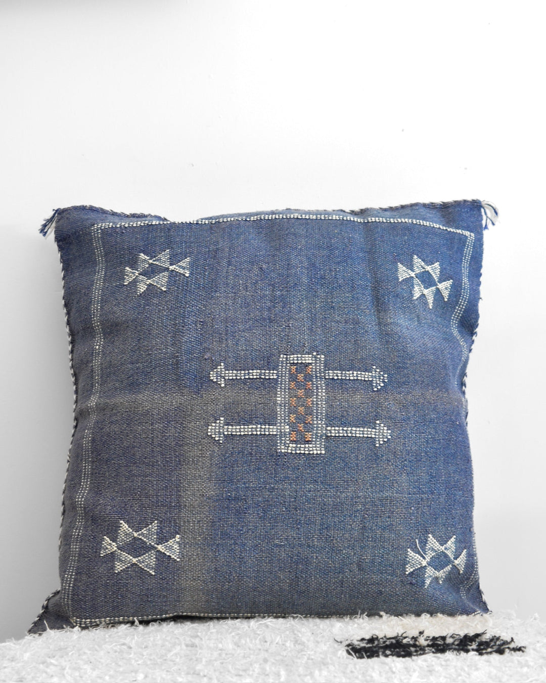 Blue patterned pillow on a white background