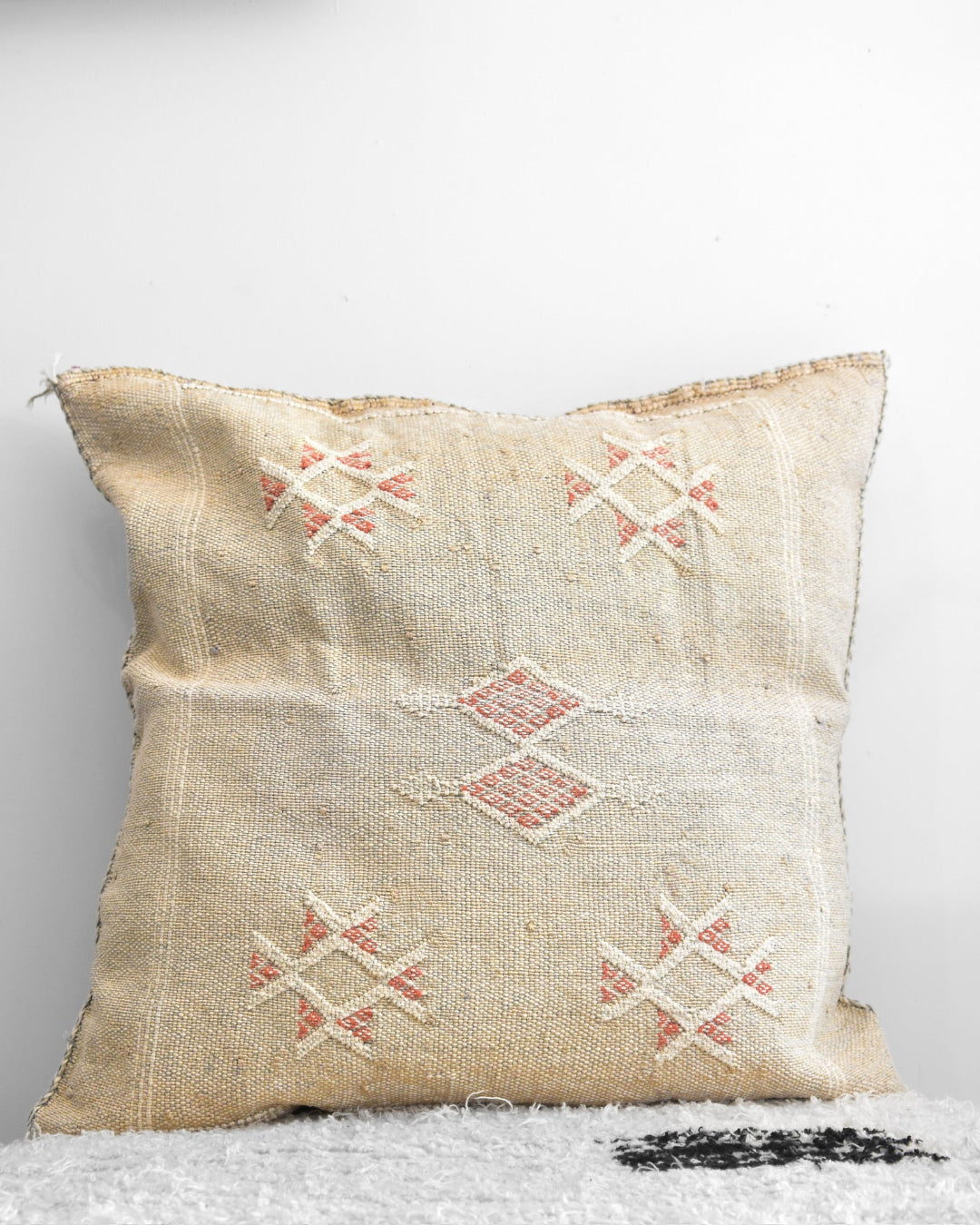 Textured pillow with geometric patterns on a white background