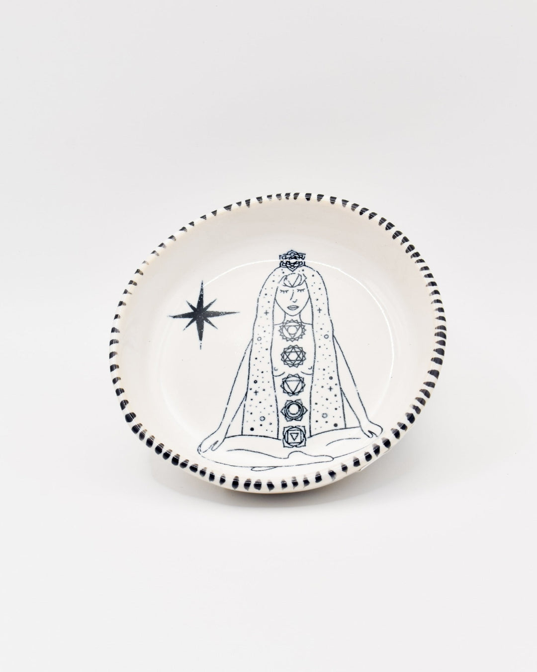 Decorative plate with a chakra and figure design on a white background