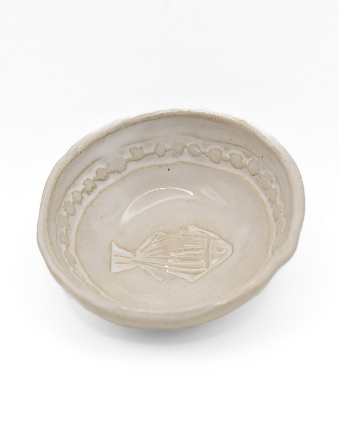 Ceramic dish with fish design on a white background
