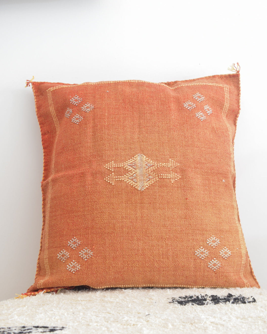 Decorative pillow with intricate patterns on a white background