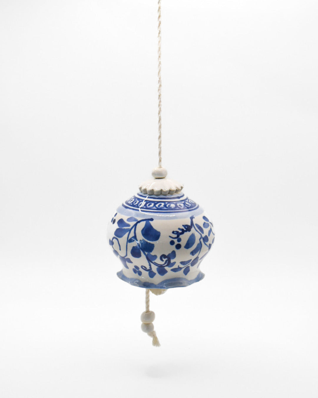 Decorative blue and white hanging ornament on a white background