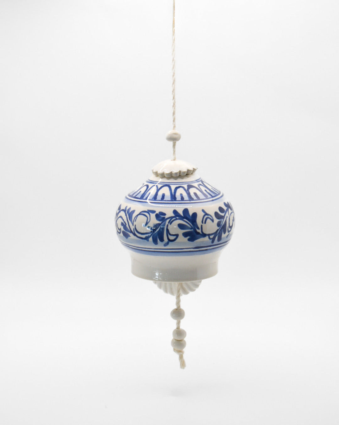 Decorative hanging ball with blue floral patterns on a white background