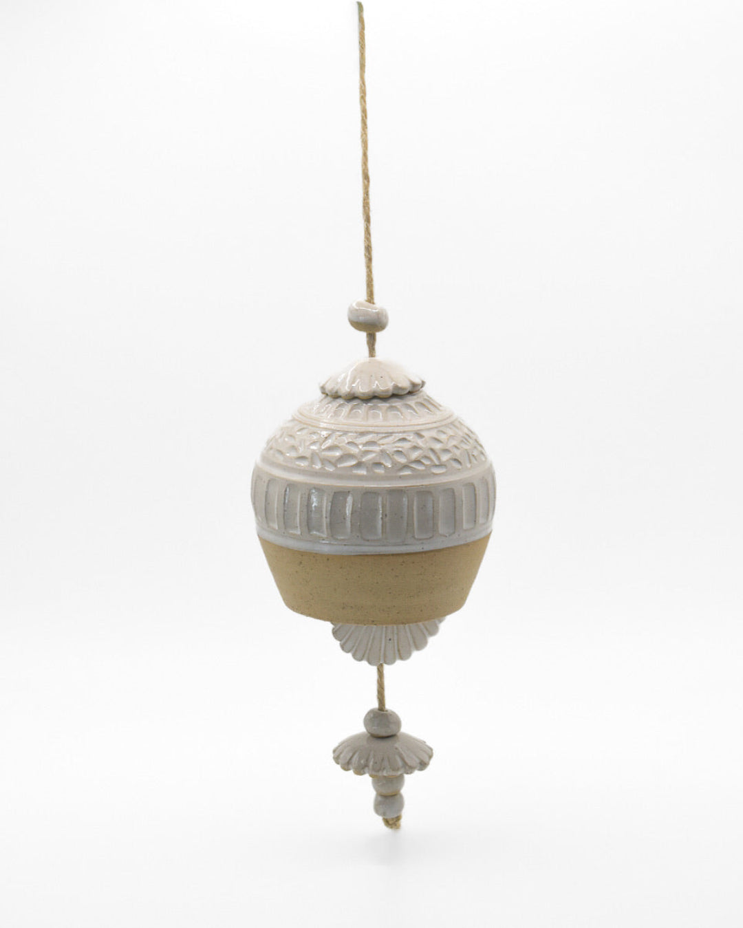 Decorative hanging ornament with intricate patterns on a white background