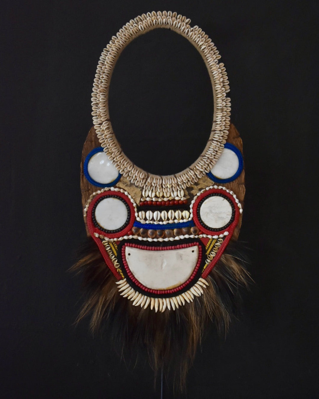 Decorative mask with intricate designs on a black background