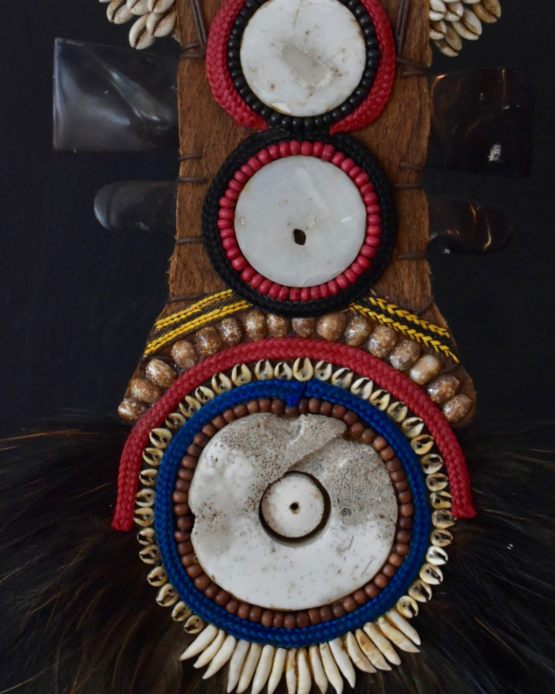 Decorative object with intricate patterns and colors on a dark background