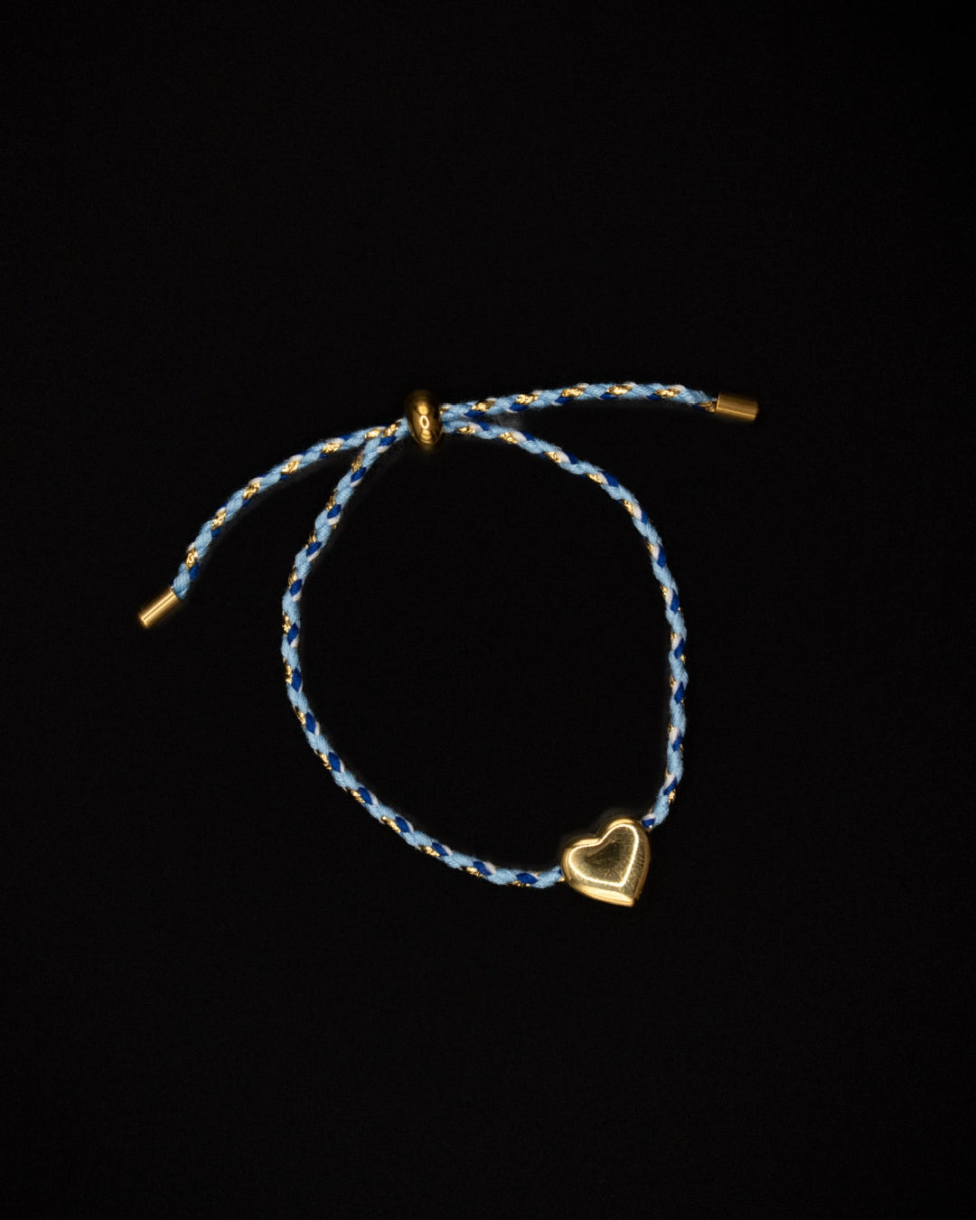 Bracelet with a heart charm on a dark background