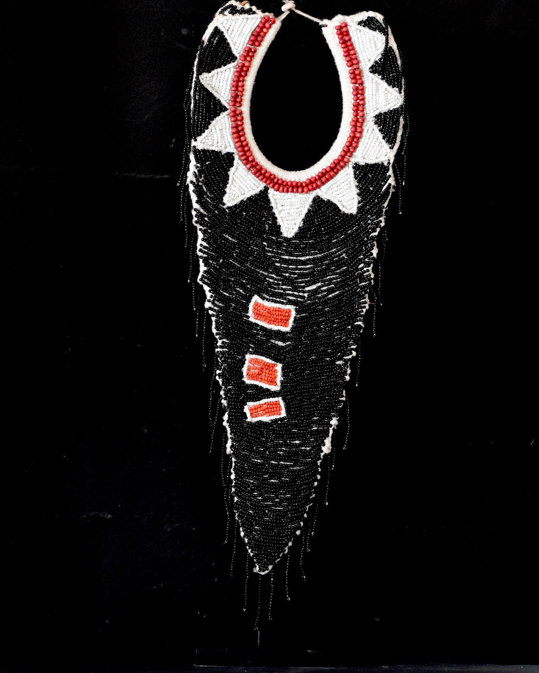 Decorative item with black, white, and red patterns on a black background