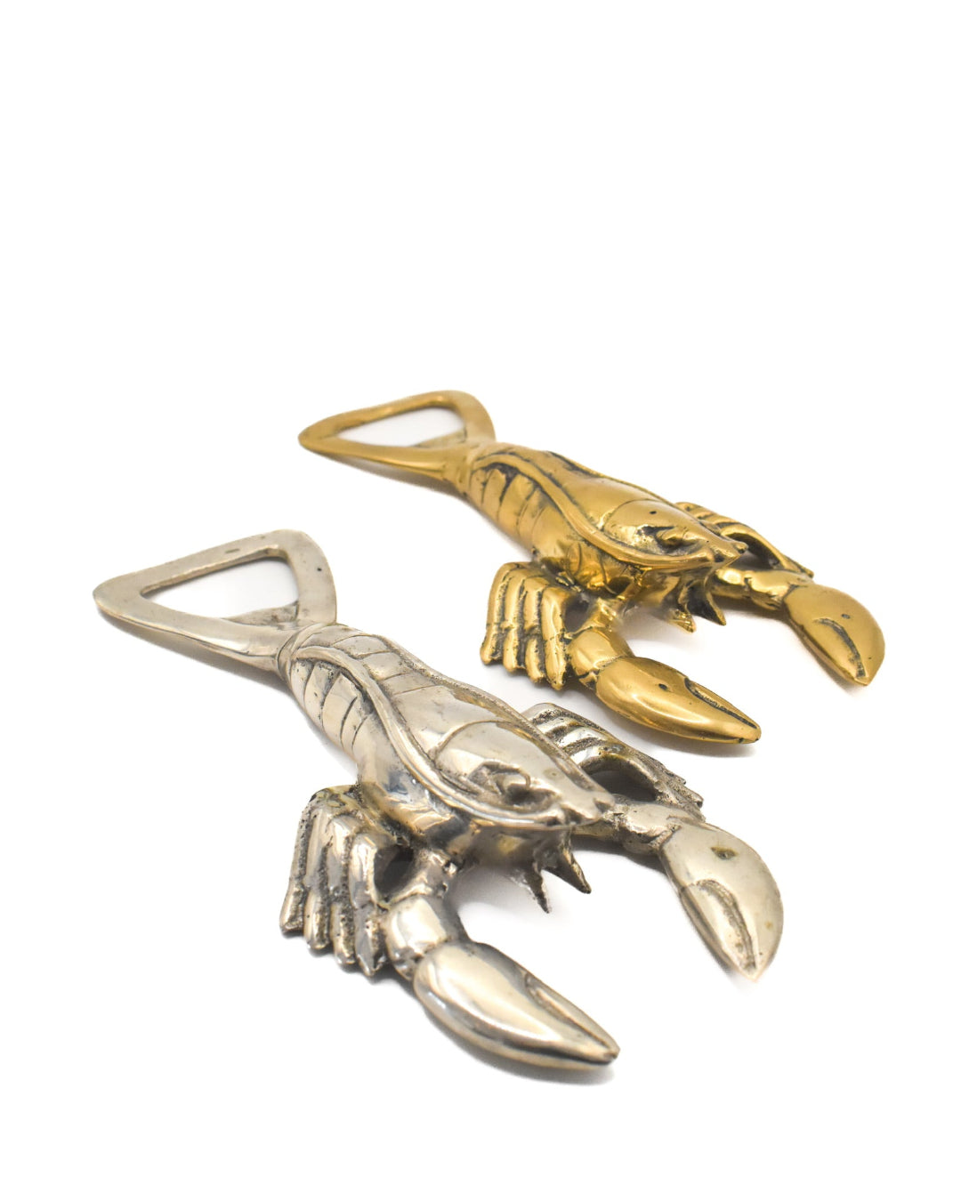 Two lobster-shaped bottle openers, one silver and one gold, on a white background.