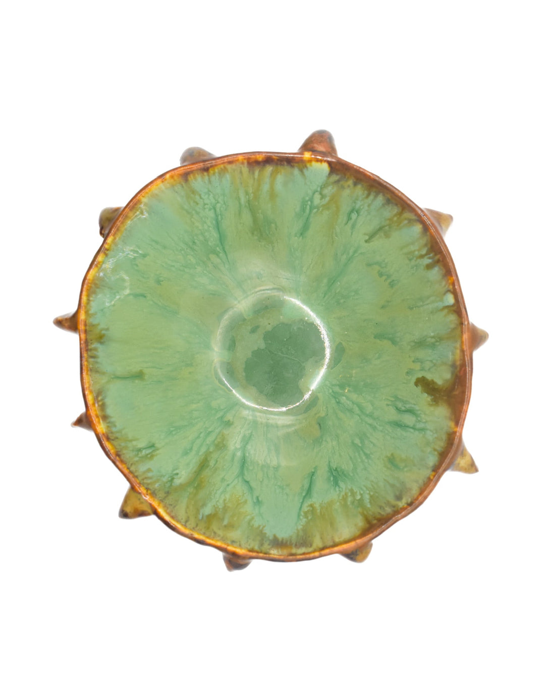 Green ceramic dish with textured edge on a white background