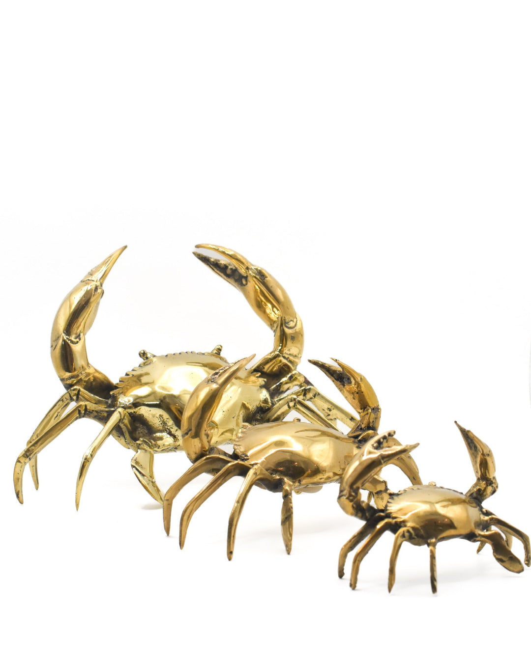 Gold crab sculpture on a white background