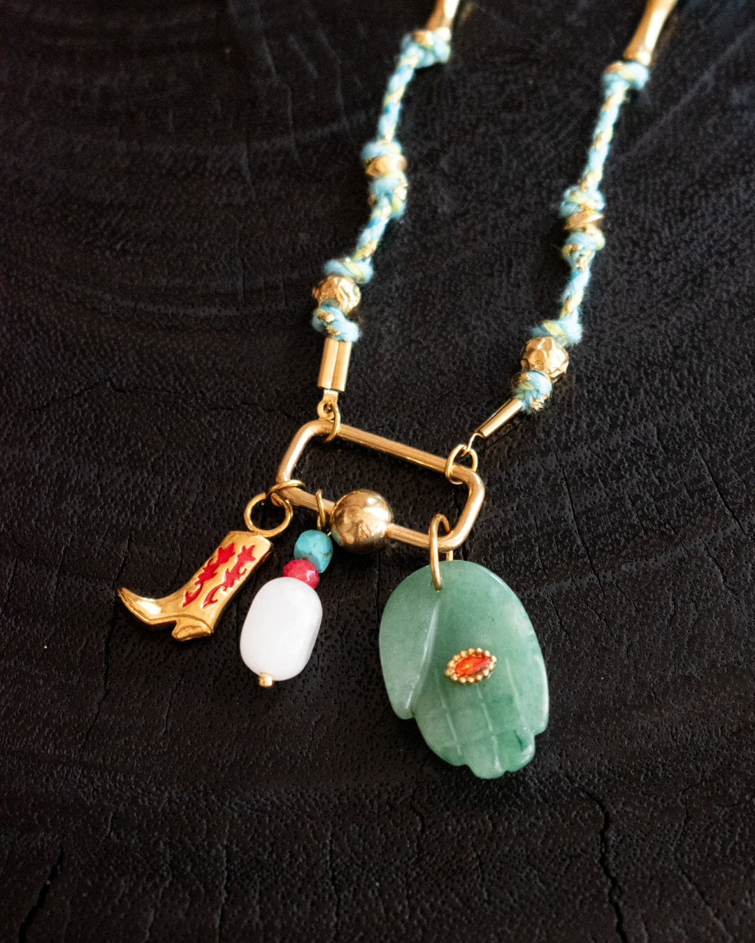 Necklace with various charms on a black background