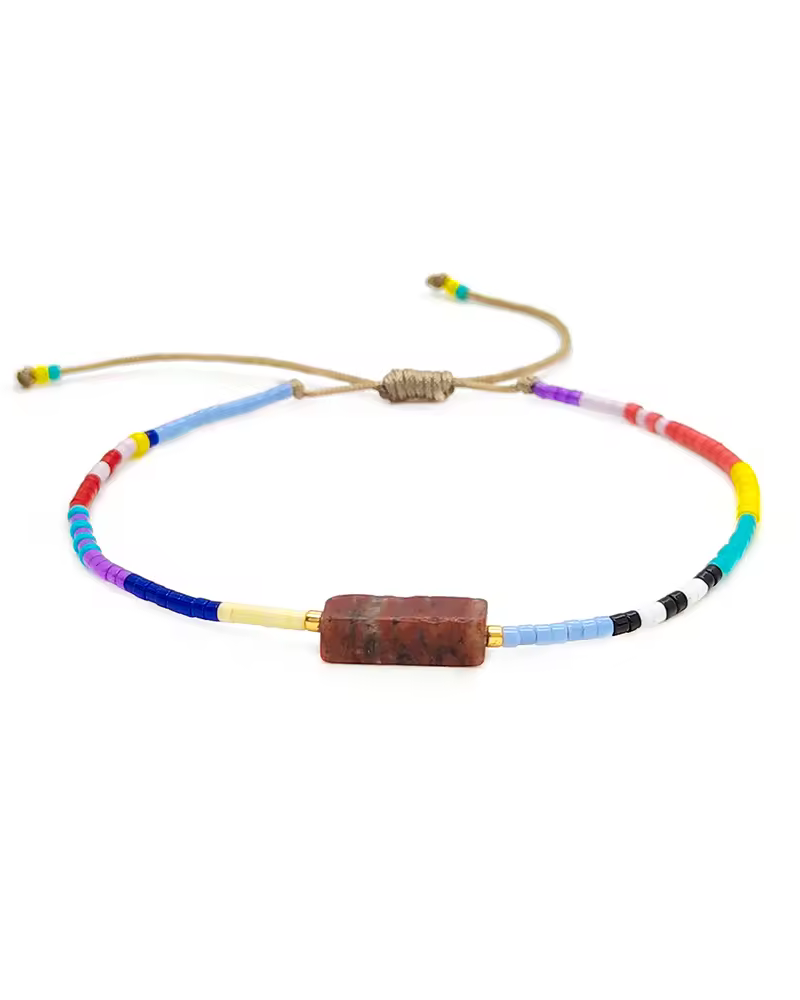 Colorful beaded necklace with a brown bead on a white background