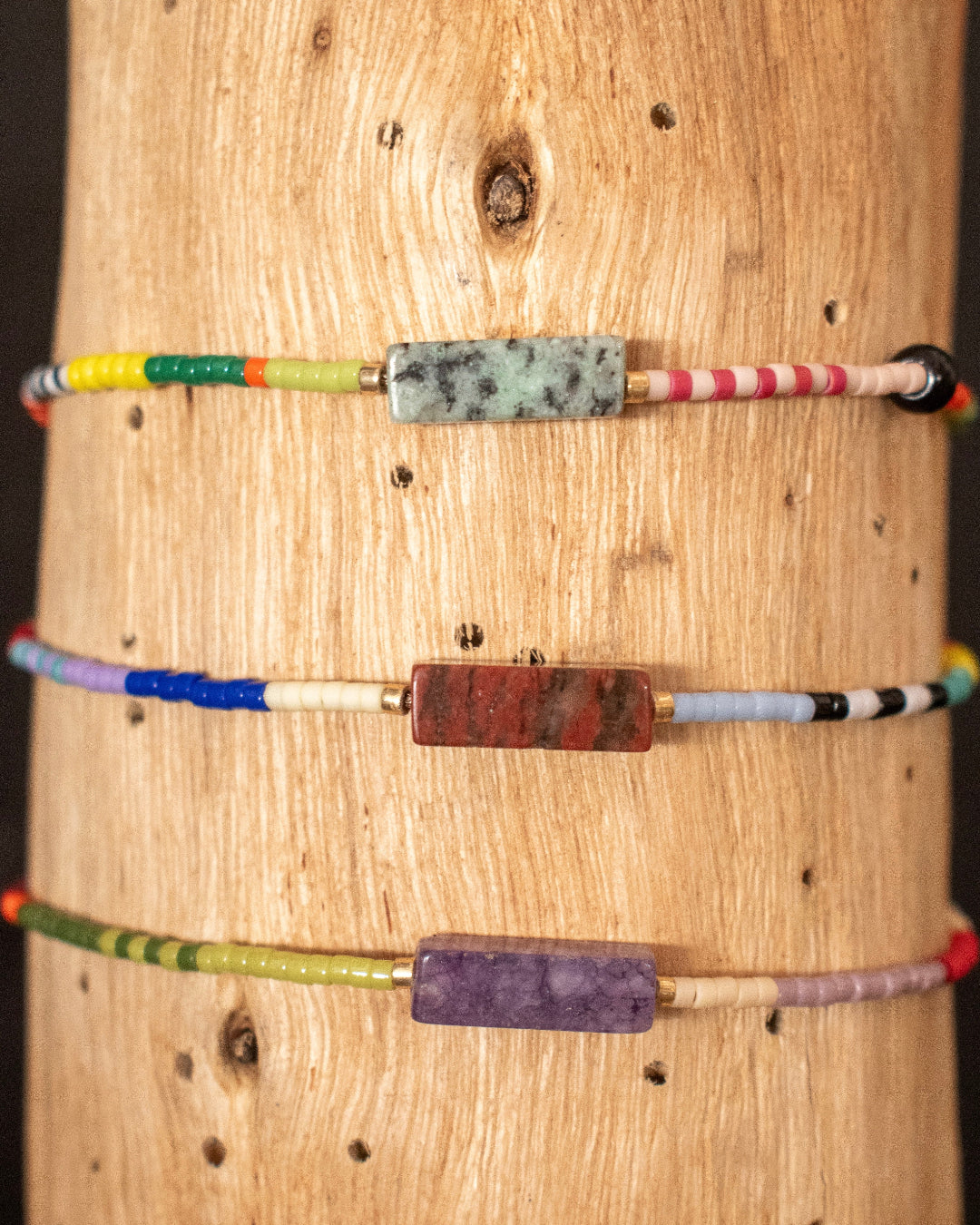 Colorful beaded bracelets on a wooden surface