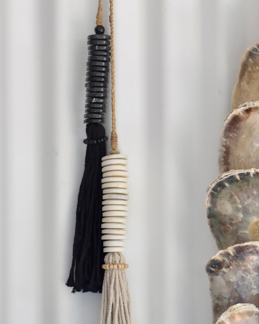 Decorative tassel with black, white elements on a white background