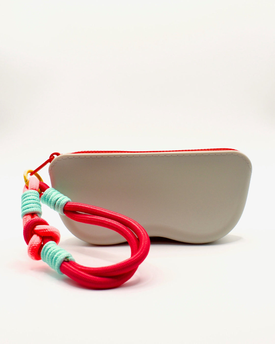 Beige pouch with colorful braided strap on a white background