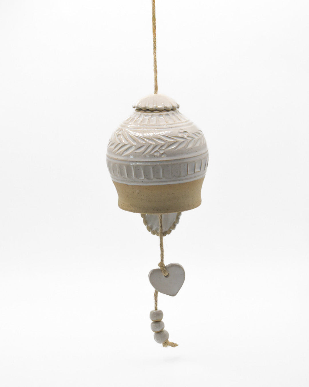 Decorative hanging ball with textured design and heart-shaped tag on a white background