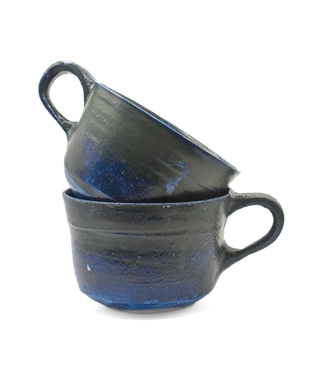 Two blue ceramic mugs stacked on a white background