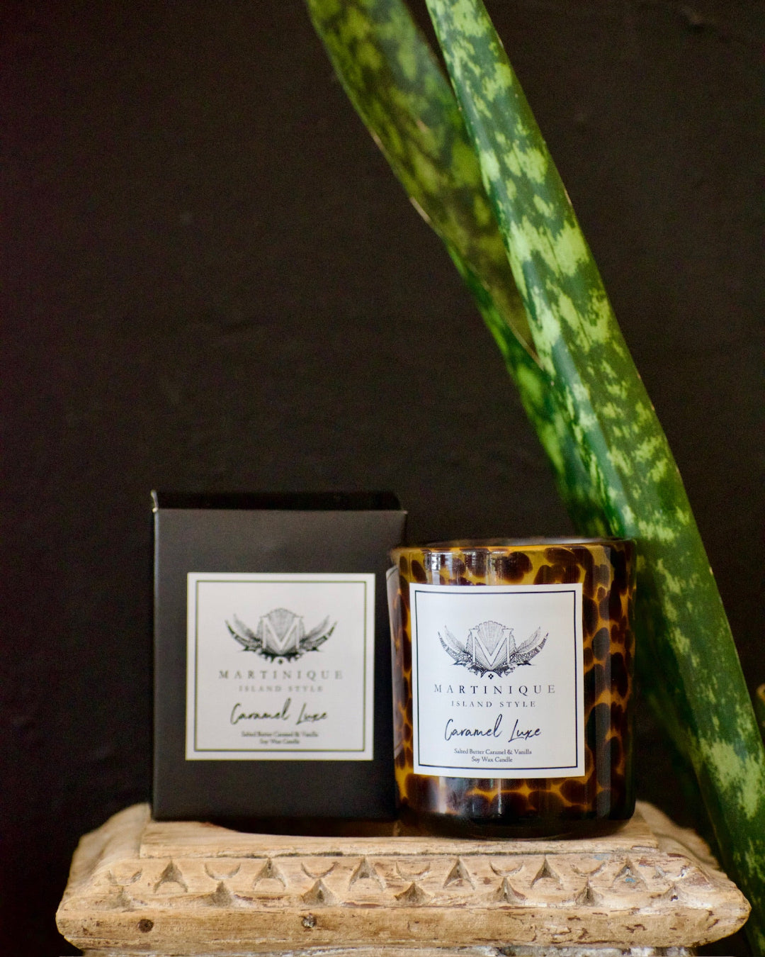 Candle and packaging with 'Martinique' branding on a dark background