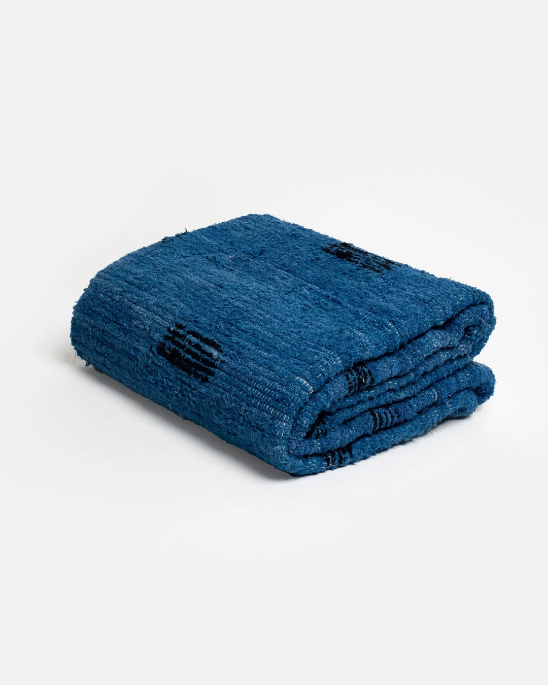 Folded blue towel with black logo on a white background