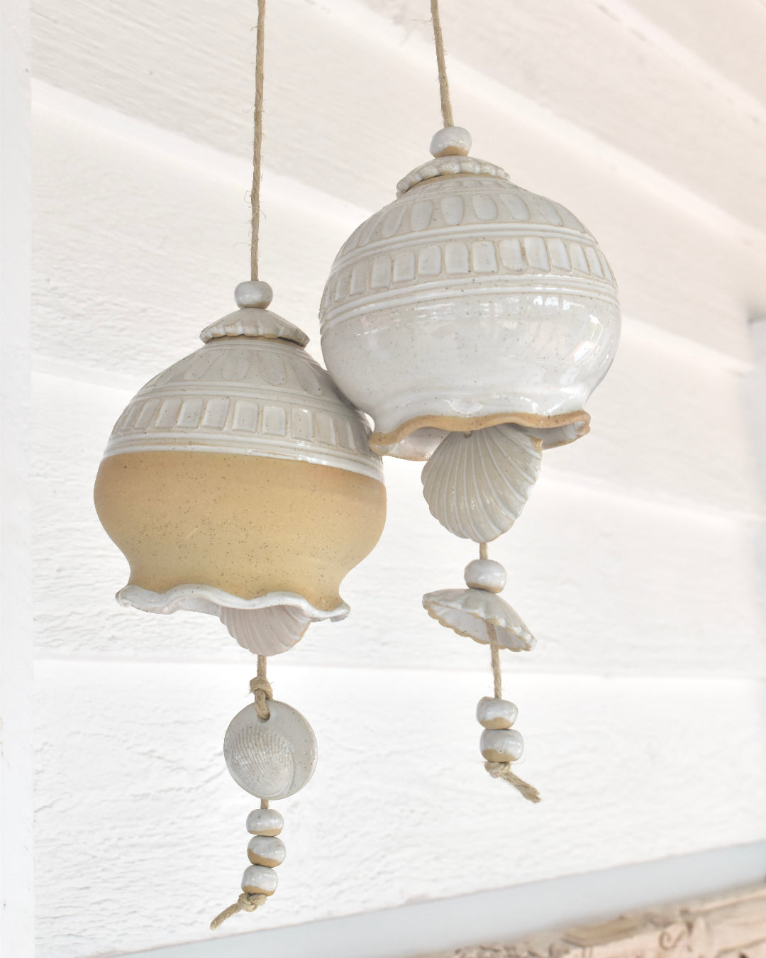 Decorative ceiling  fixture with shell design against a white ceiling.