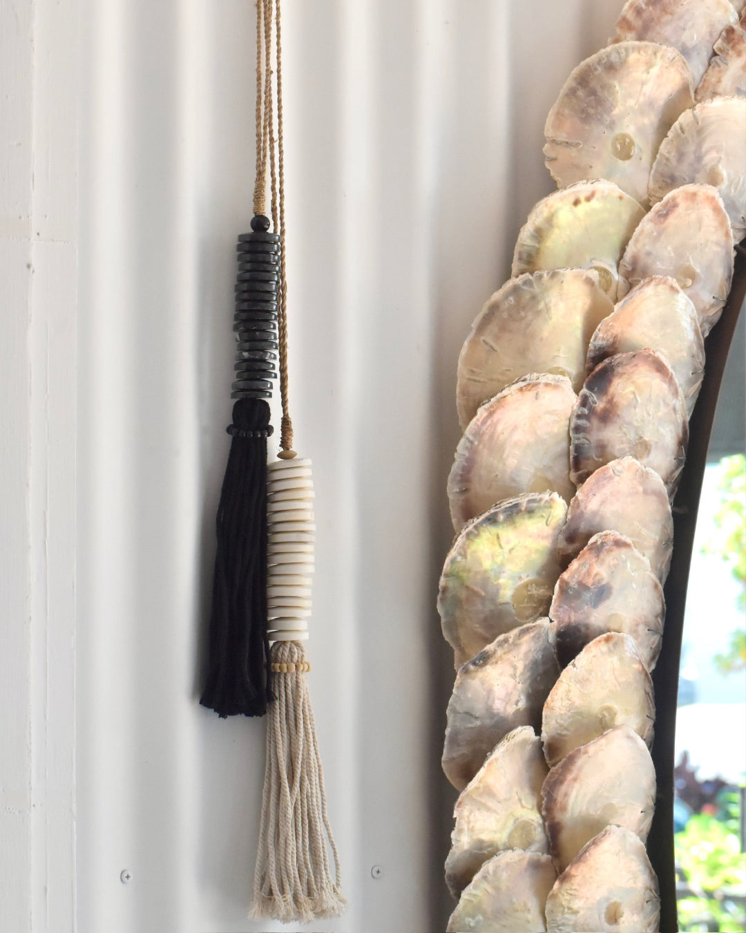 Decorative marble tassel against a white wall