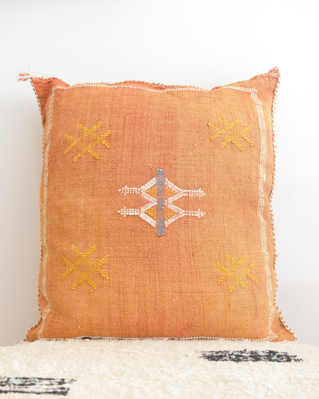Decorative pillow with geometric patterns on a white background