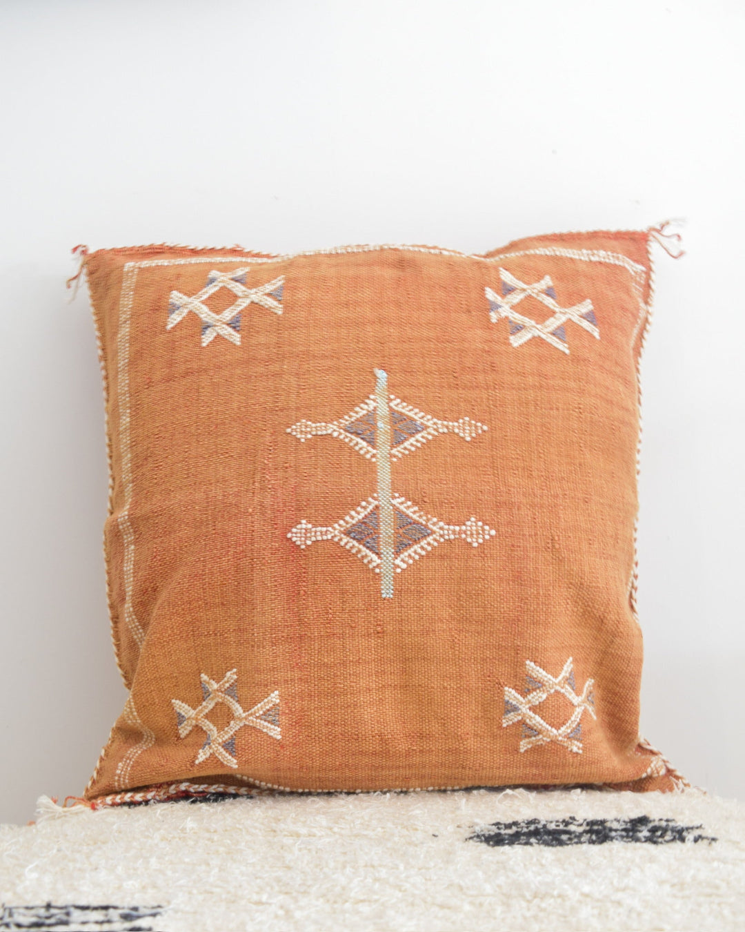 Decorative pillow with geometric pattern on a white background