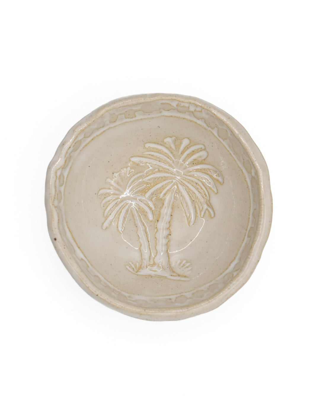 Round beige ramekin with a palm tree design on a white background