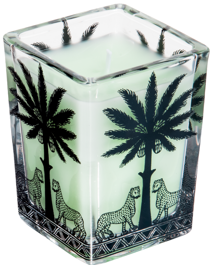 A square glass candle holder with a pale mint green wax and black tropical designs of palm trees and cheetahs, set against a plain white background.