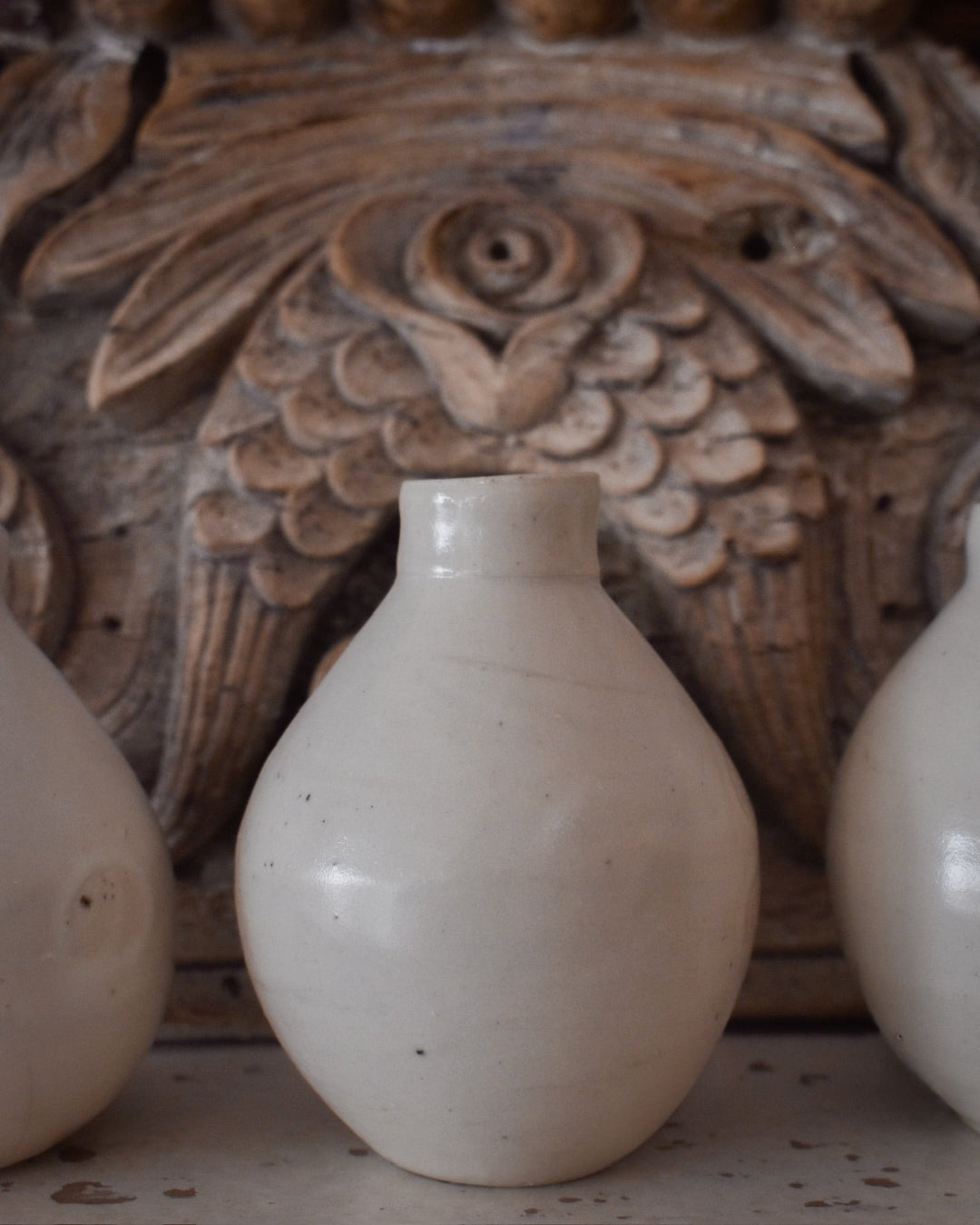 White ceramic bottle with a wooden background