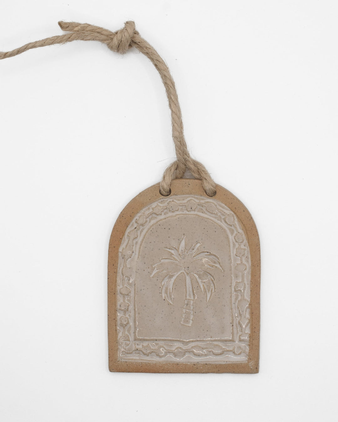 Decorative tag with palm tree design on a white background