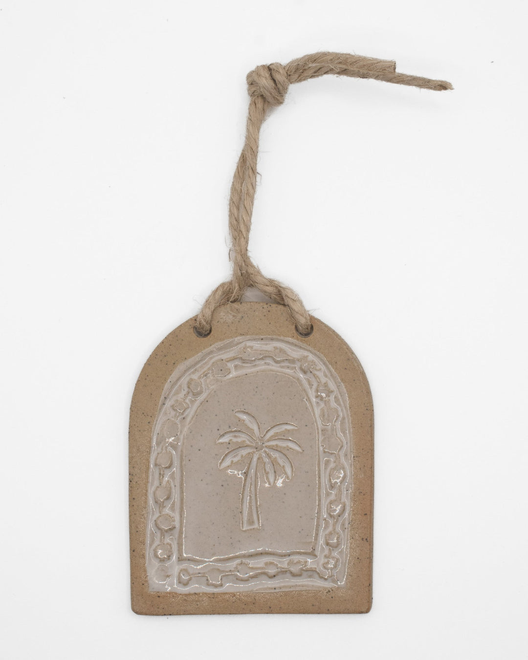 Decorative tag with palm tree design on a white background