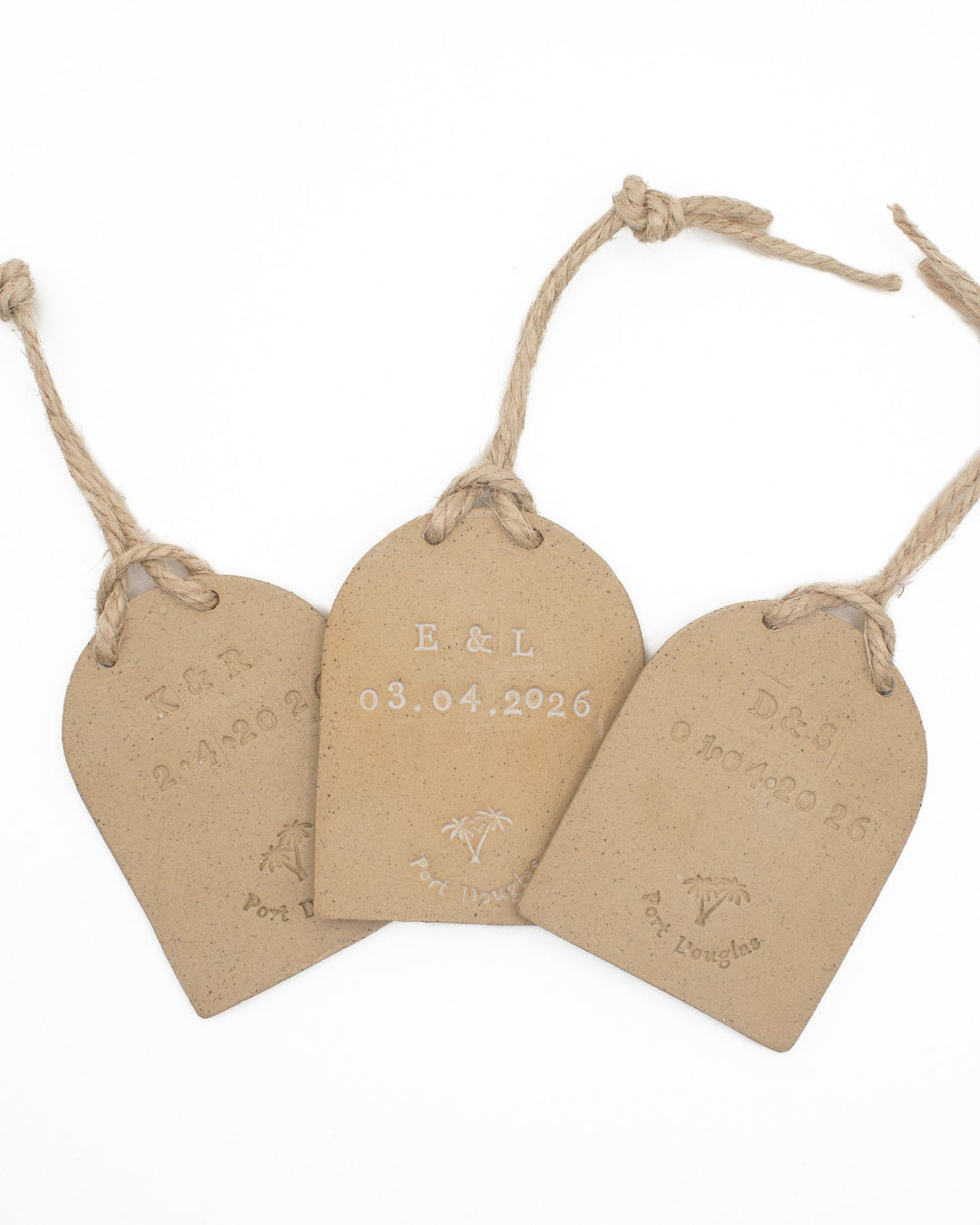 Three arch tags with personalised text on a white background