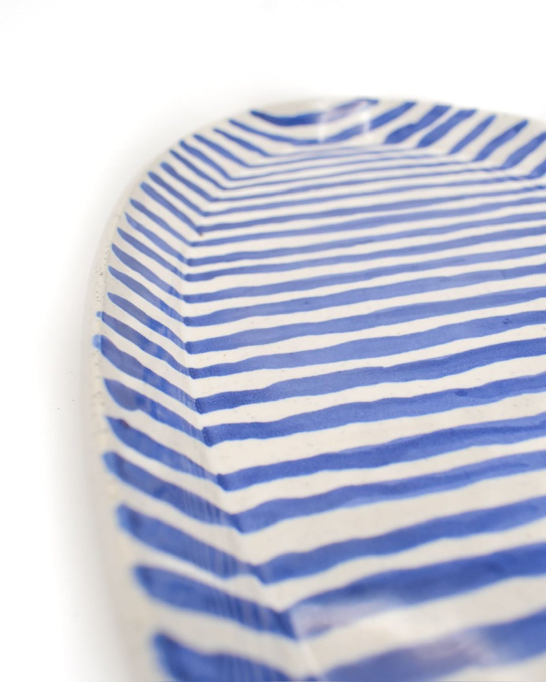 Blue and white striped ceramic serving tray on a white background