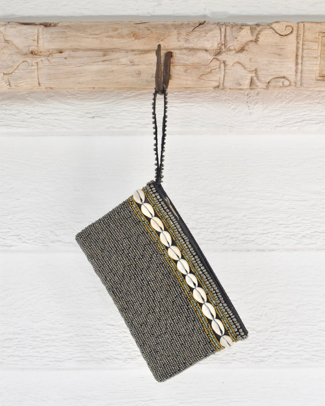 silver beaded clutch and shell pattern on a white background